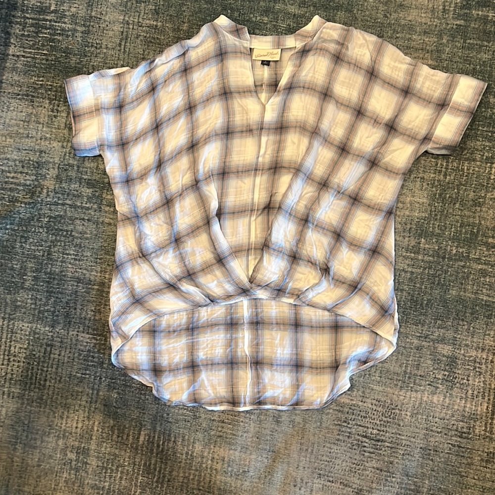 Sort in front long in back white with blue and gray plaid
